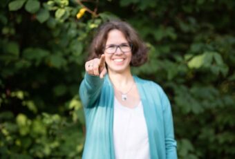 Marie Meyer Marktl deutet mit den Finger in die Kamera.